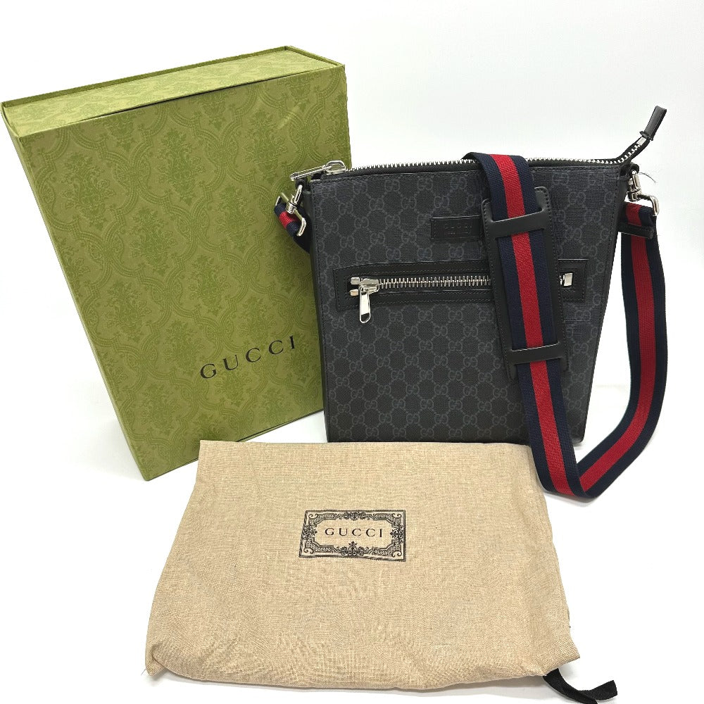 Gucci handbag with green box and beige pouch on a white background