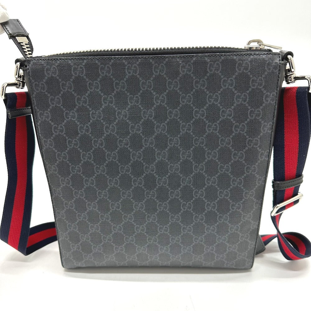 Gray patterned bag with red and blue straps on a white background