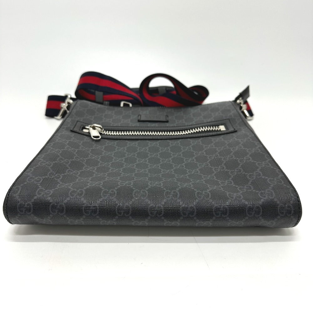 Gray handbag with a patterned strap on a white background