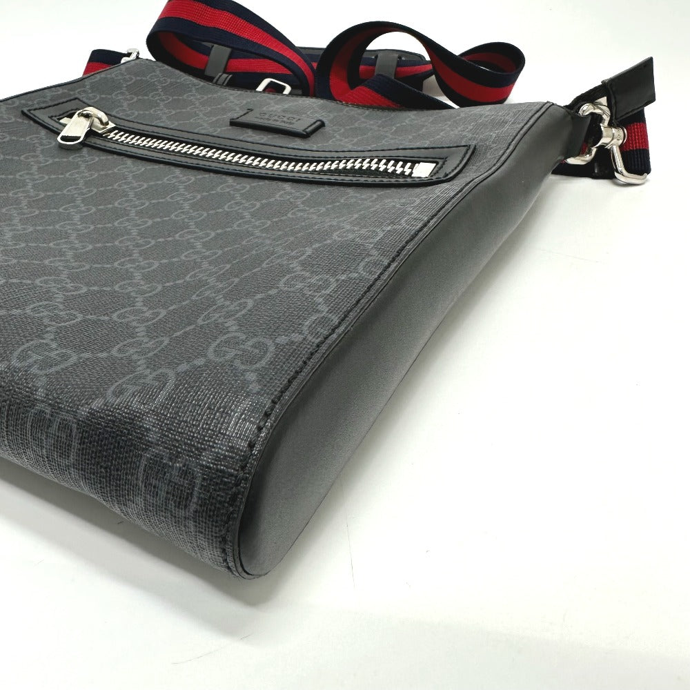 Gray patterned handbag with a strap on a white background