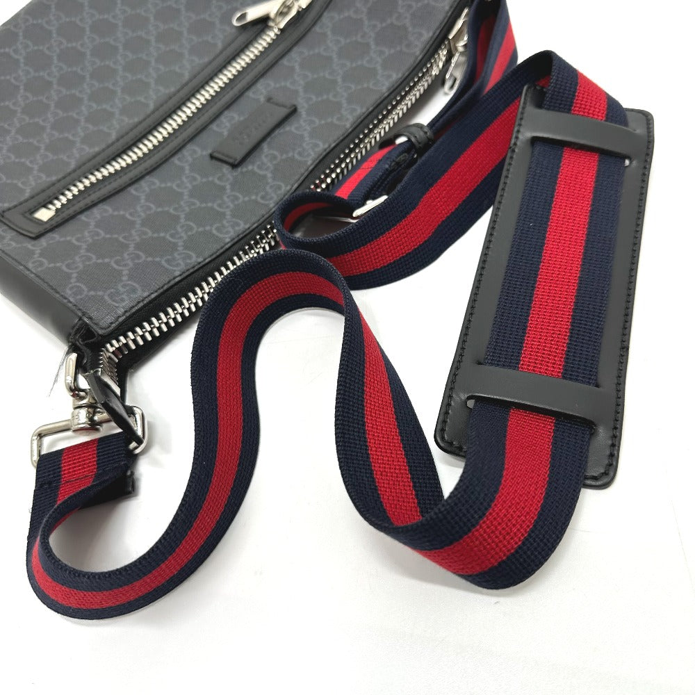 Gray bag with a red and blue striped strap on a white background