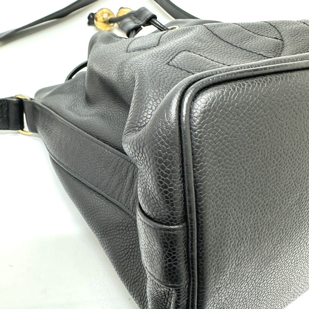 Close-up of a gray leather handbag with a textured surface on a white background