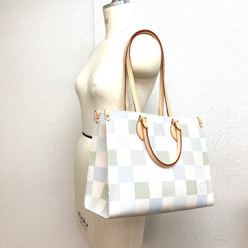White checkered handbag with brown handles on a mannequin against a white background