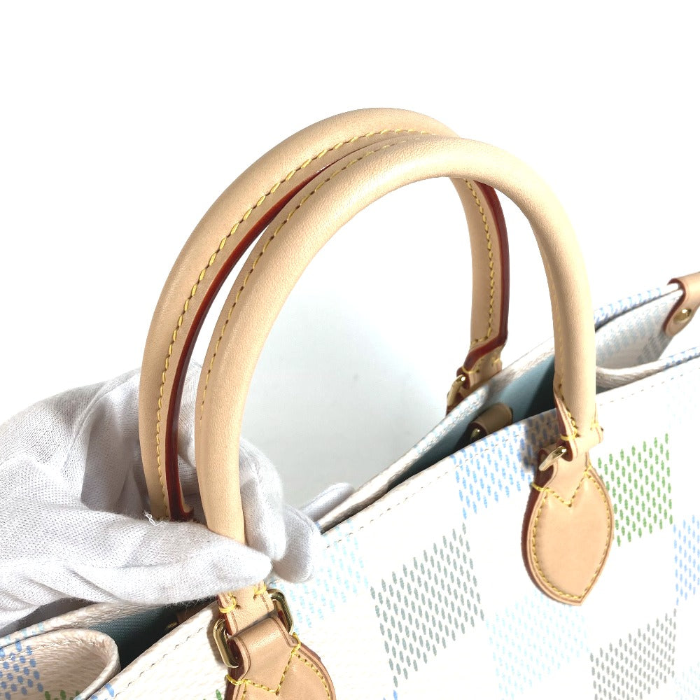 Close-up of a handbag with beige handles and trim on a light background