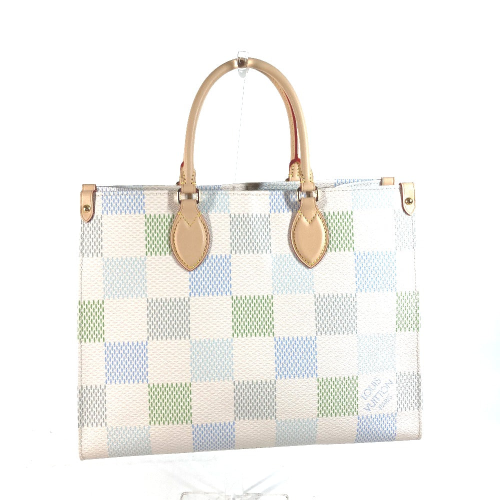 Checkered handbag with gold handles and accents on a white background