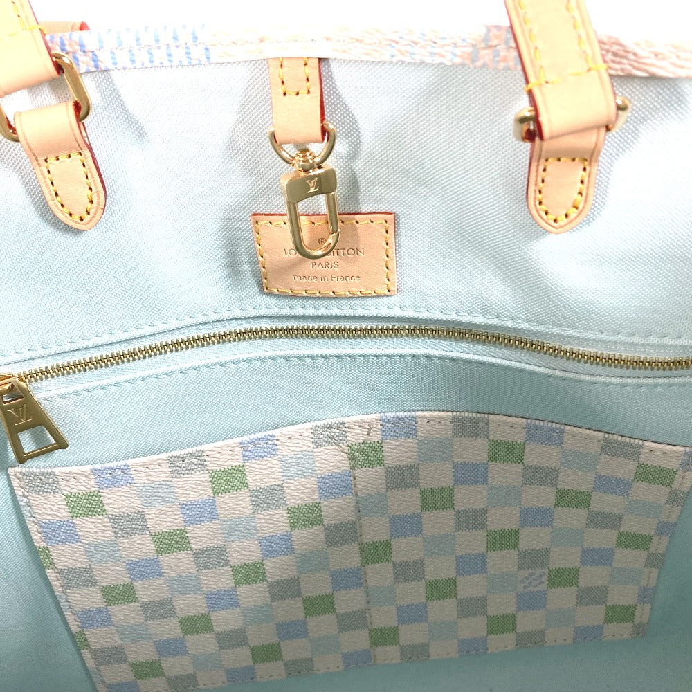 Light blue handbag with checkered pocket and gold hardware, featuring a visible brand tag.