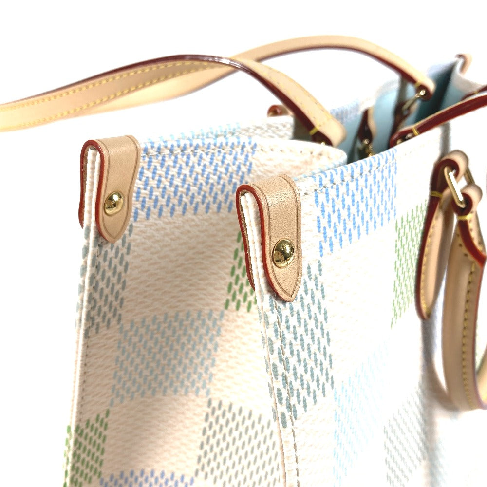 Close-up of a handbag with a textured surface and leather accents.