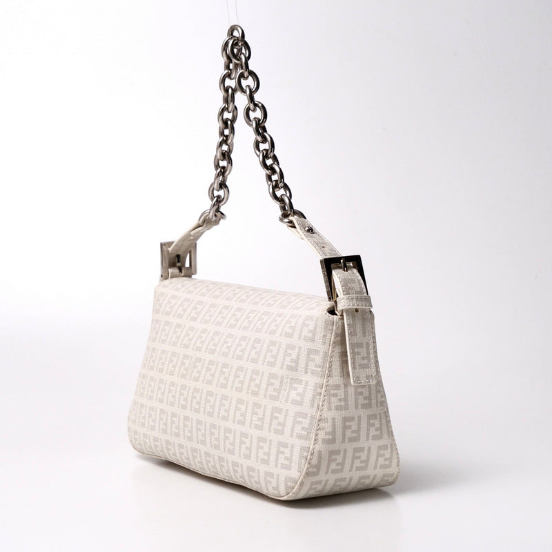 White handbag with chain strap on a white background