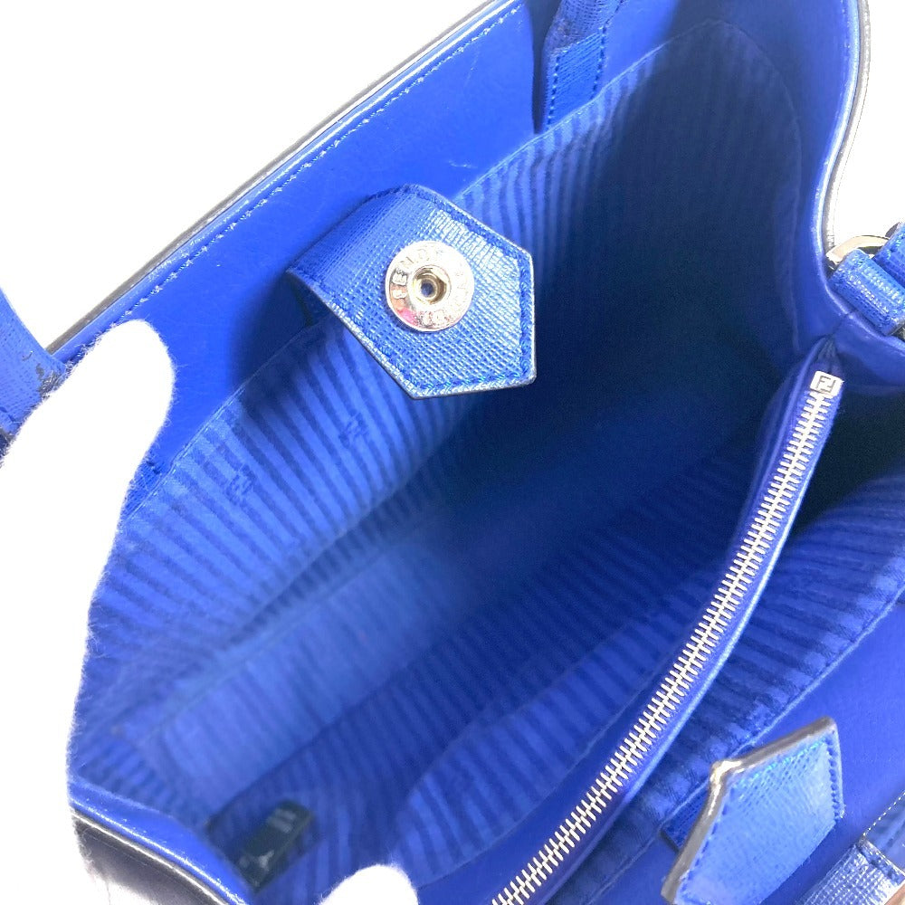 Close-up of a blue textured handbag with a gold zipper.