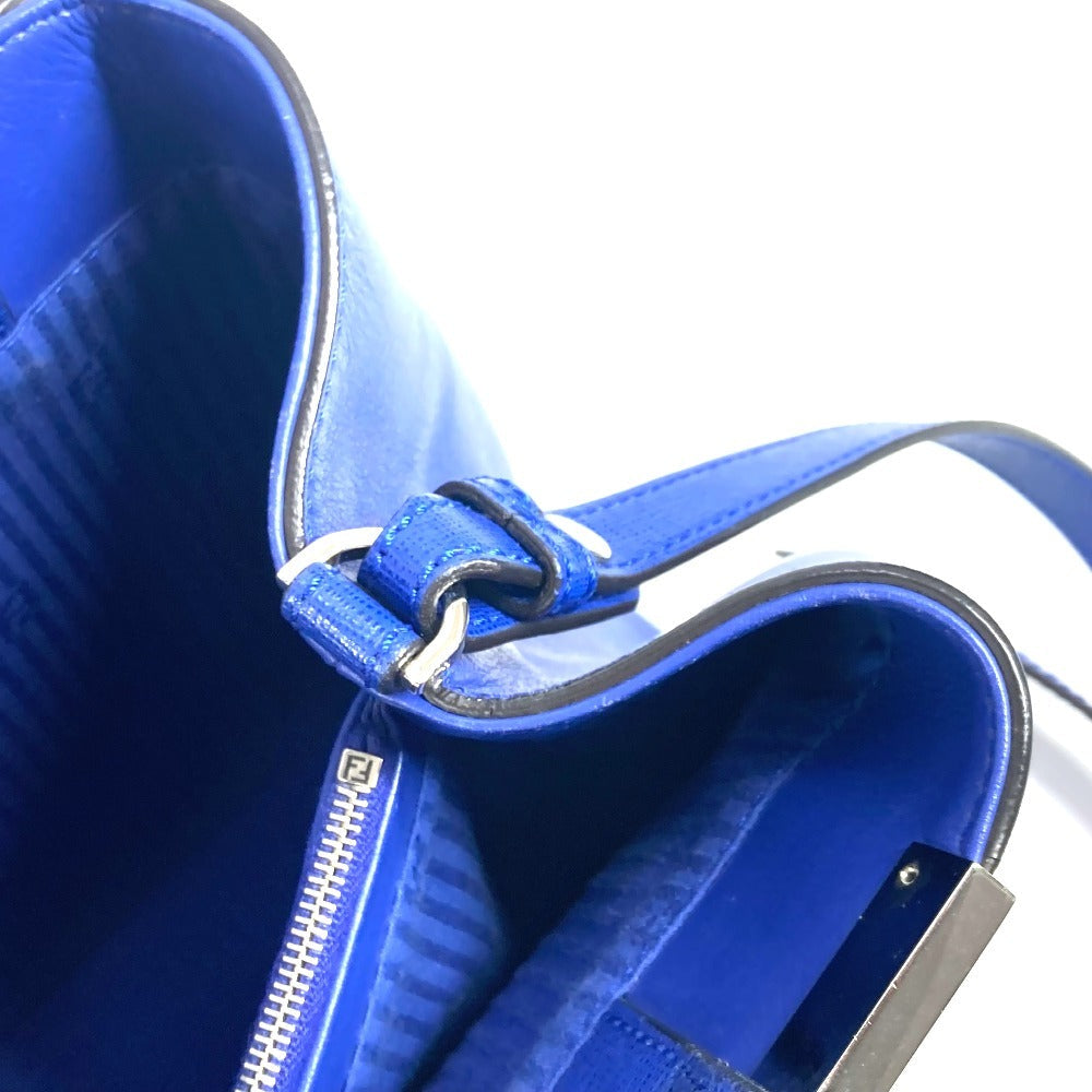 Close-up of a blue leather bag with a zipper on a white background