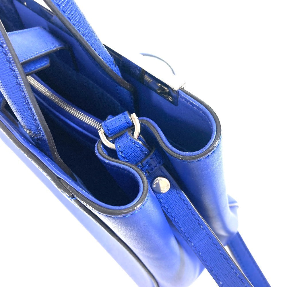 Close-up of a blue handbag with a zipper and strap on a white background
