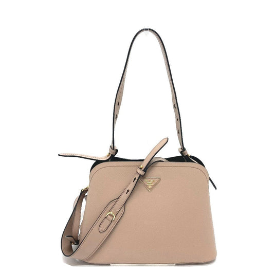Beige handbag with a strap on a white background