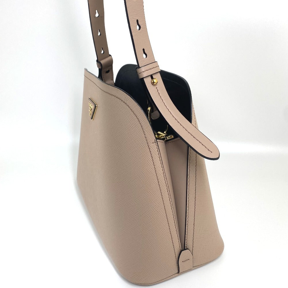 Beige handbag with a strap on a white background