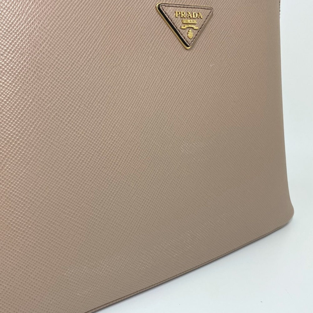 Beige handbag with Prada logo on a white background
