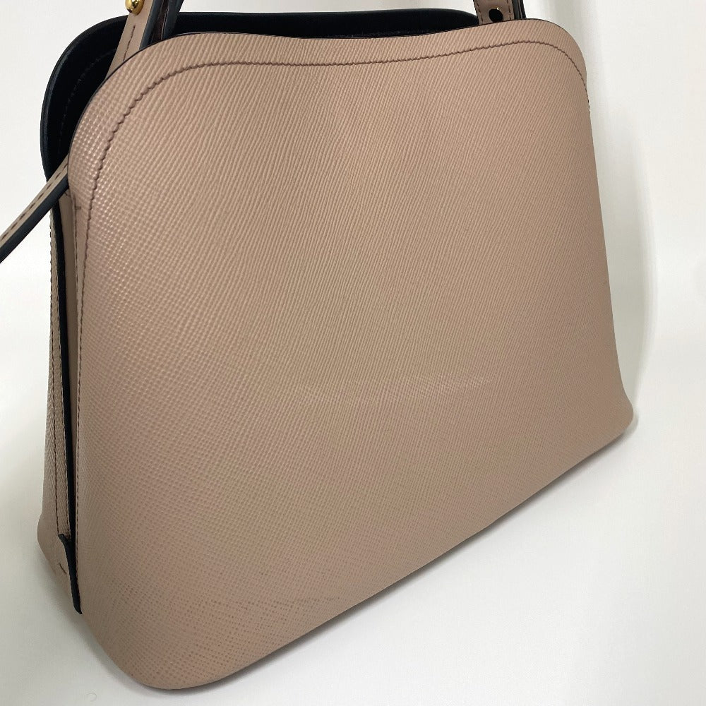 Beige handbag with black handle on a white background