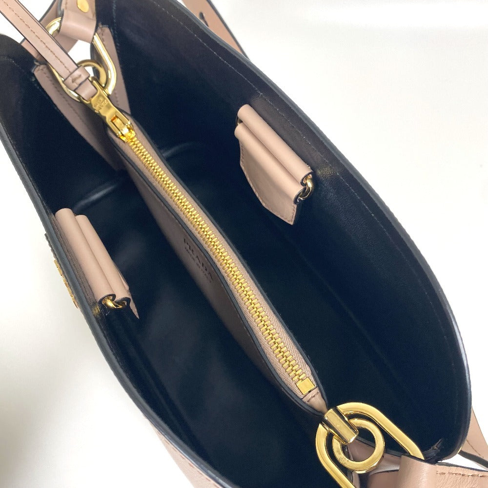 Close-up of a handbag with gold zipper and handle on a white background