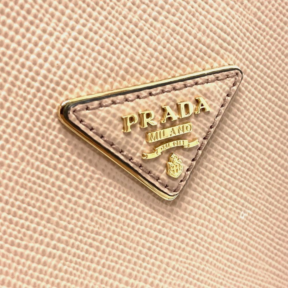 Close-up of Prada logo on a pink textured background