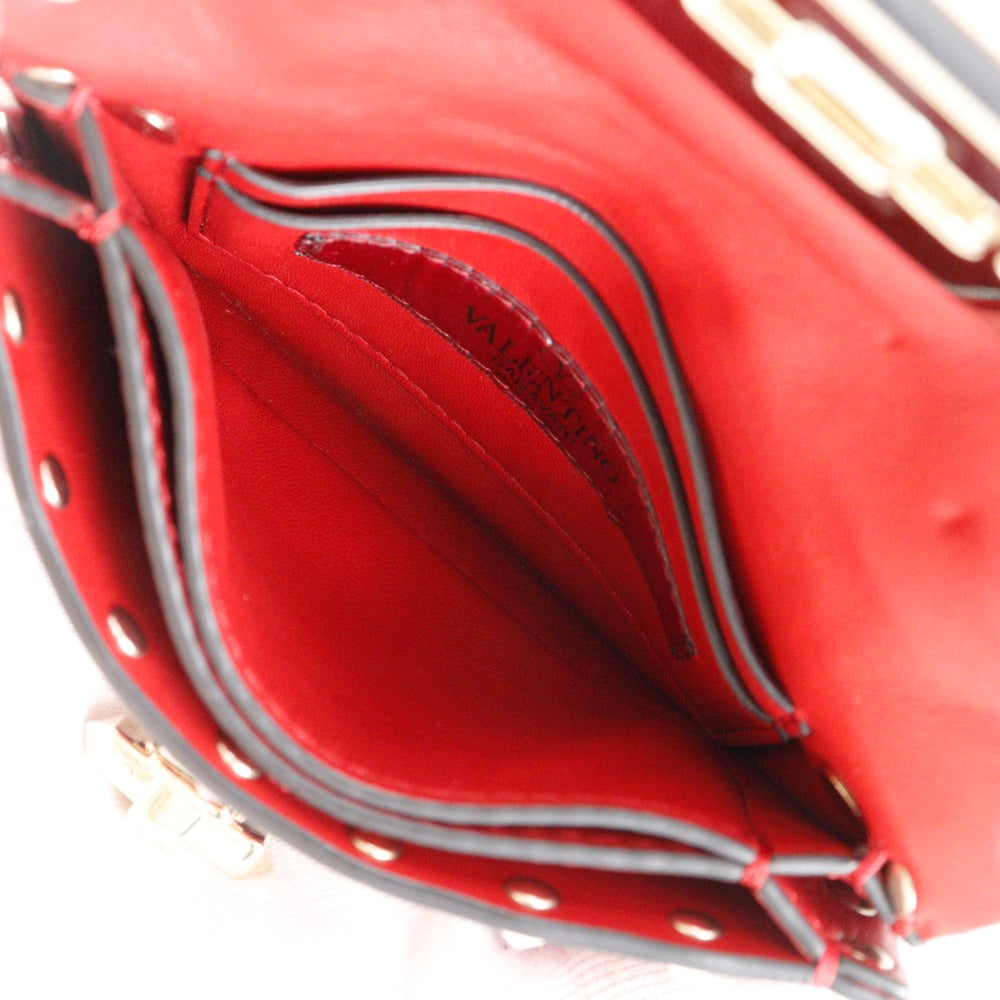 Close-up of a red handbag with visible stitching details.