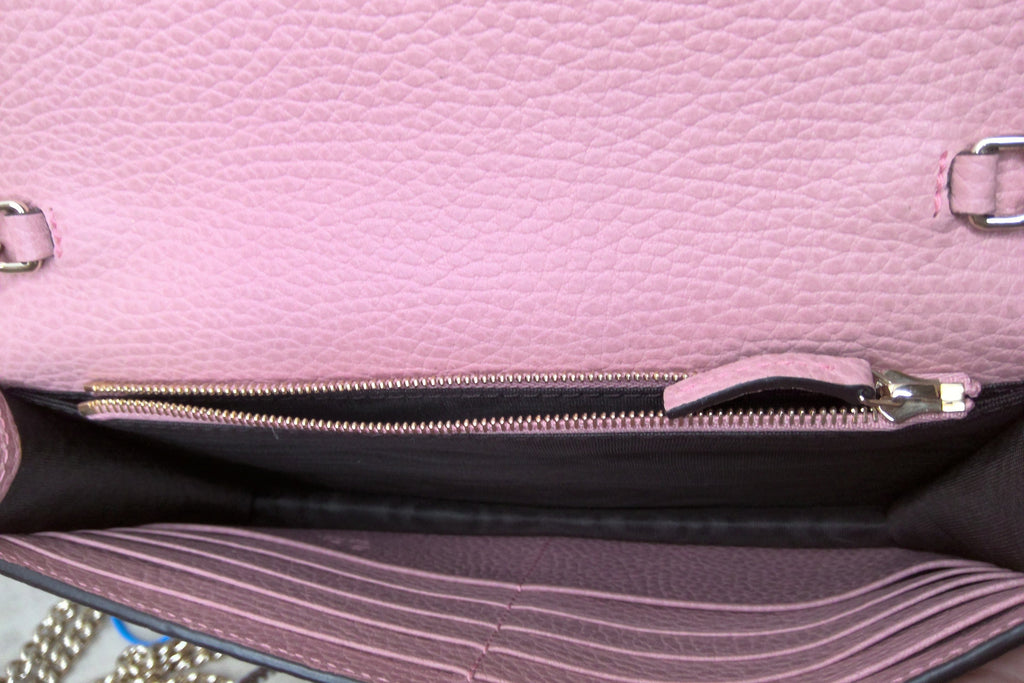 Close-up of a pink handbag with a zipper