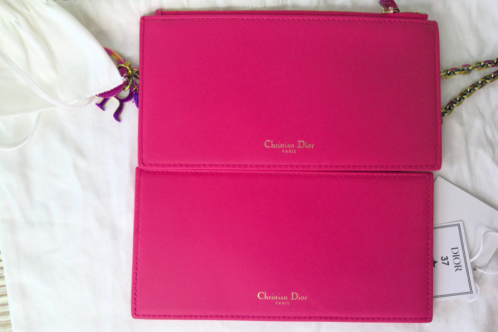Pink Christian Dior handbag on a white surface