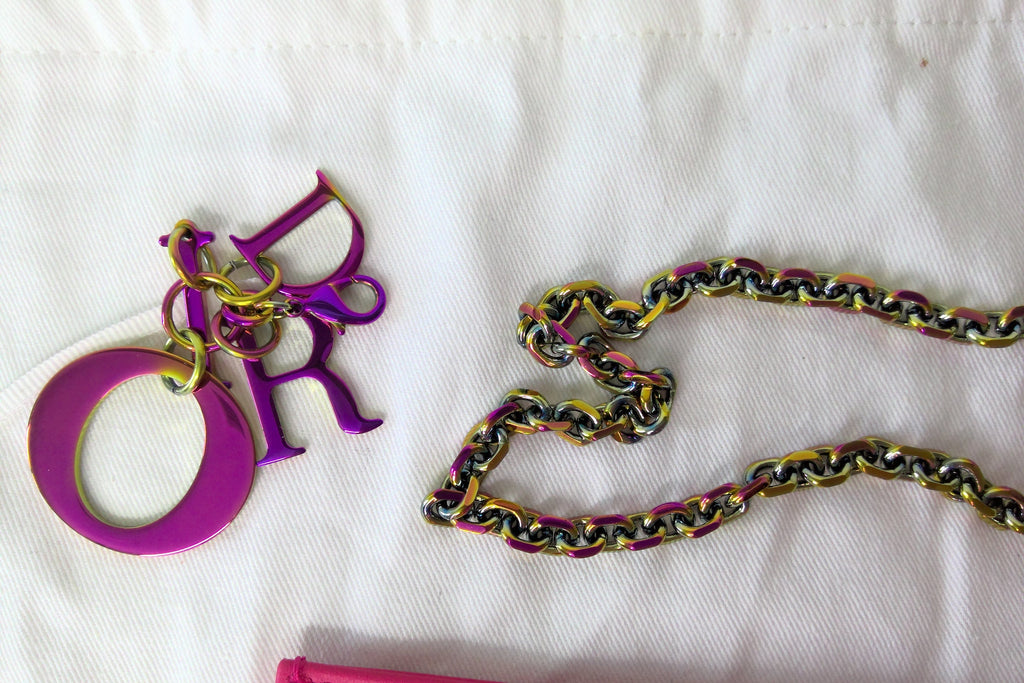 Colorful chain and decorative letter 'R' on a white background