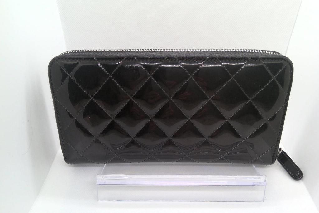 Black quilted wallet on a white background