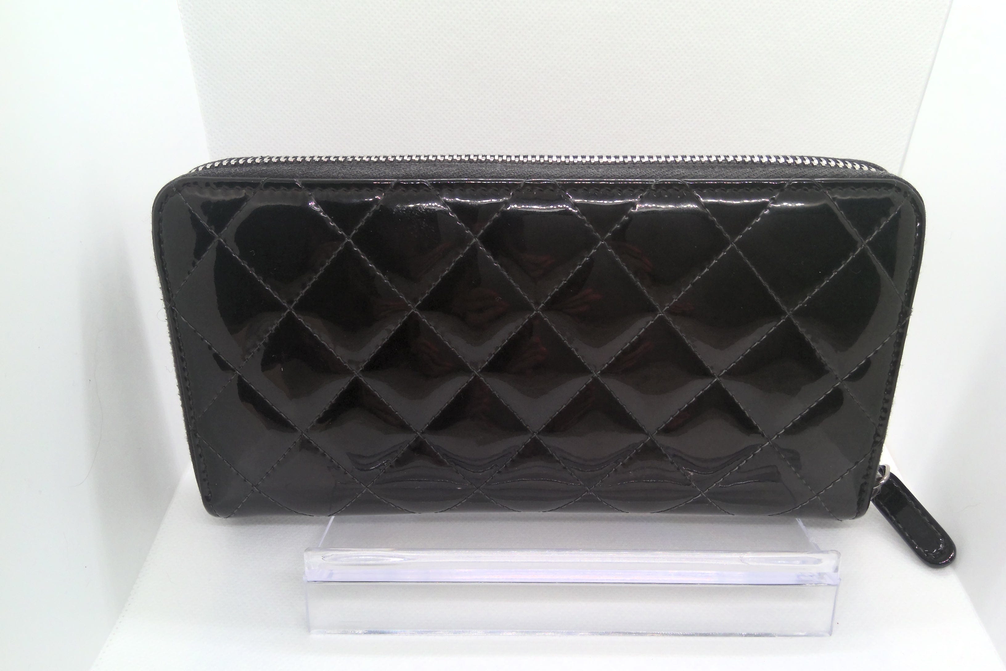 Black quilted wallet on a white background