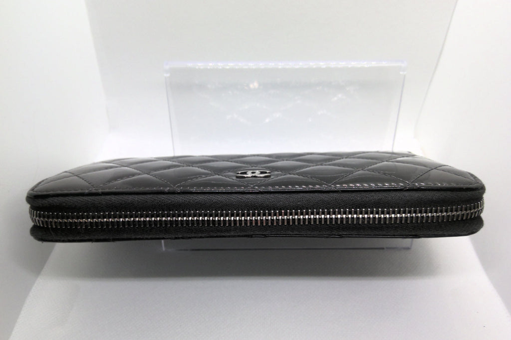 Black quilted clutch bag on a white background