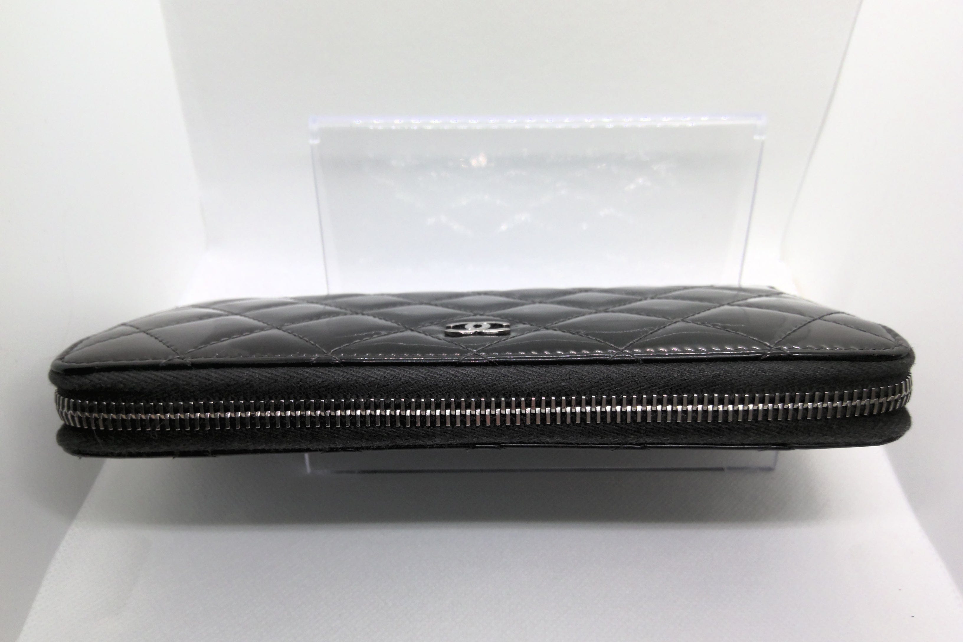 Black quilted clutch bag on a white background