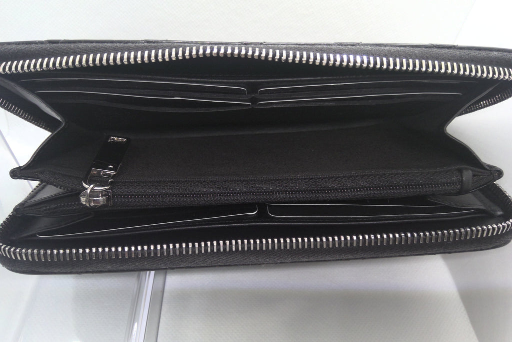 Black leather wallet with silver zipper on a white background