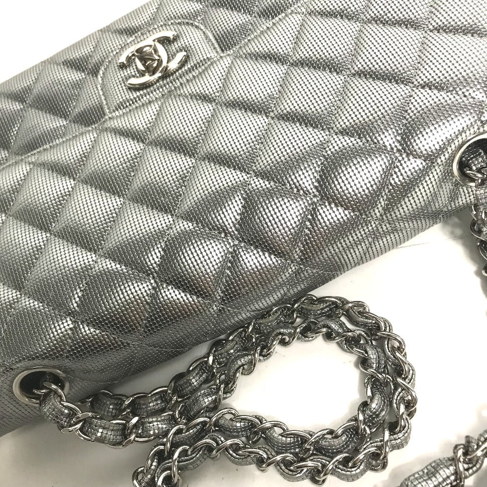 Silver quilted handbag with chain strap on a white background