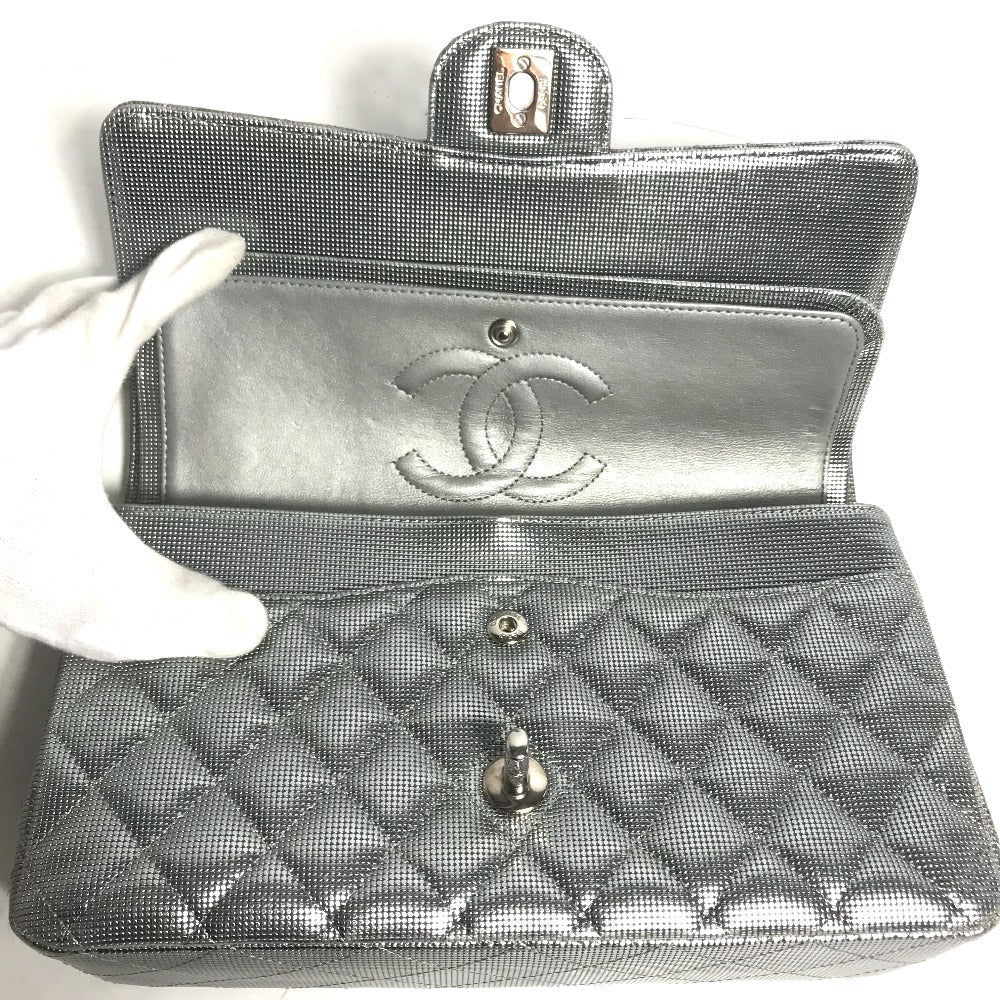 Silver quilted handbag with Chanel logo on a white background