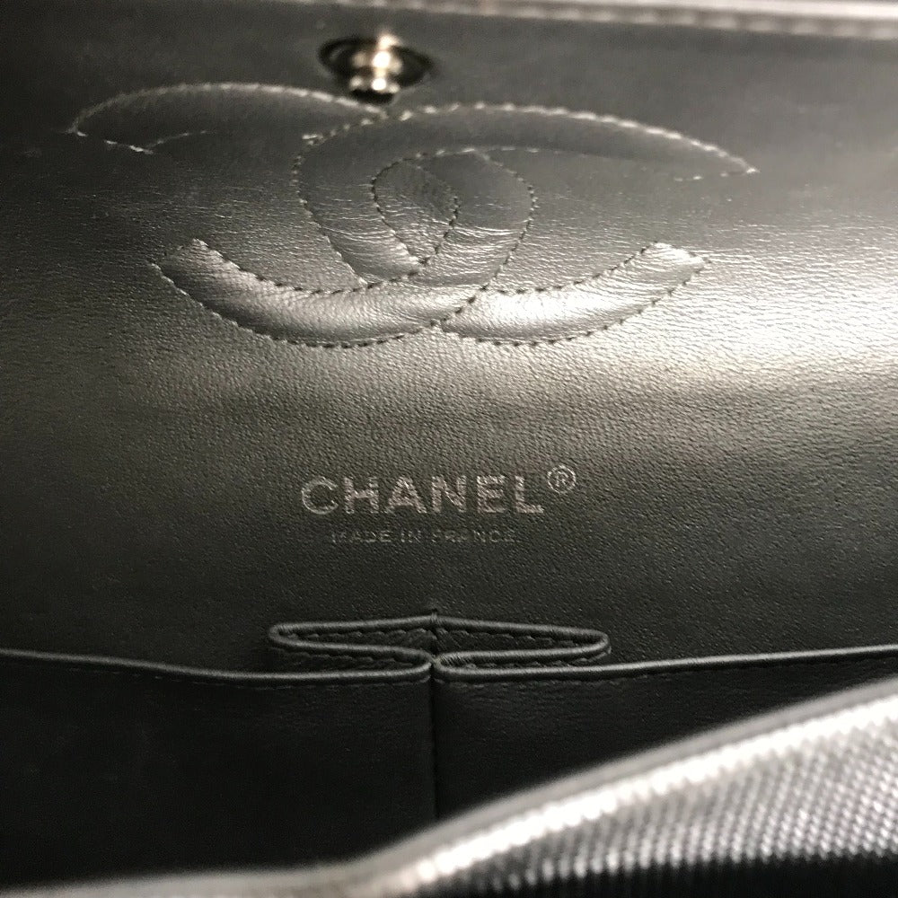 Close-up of a Chanel handbag with logo and branding.