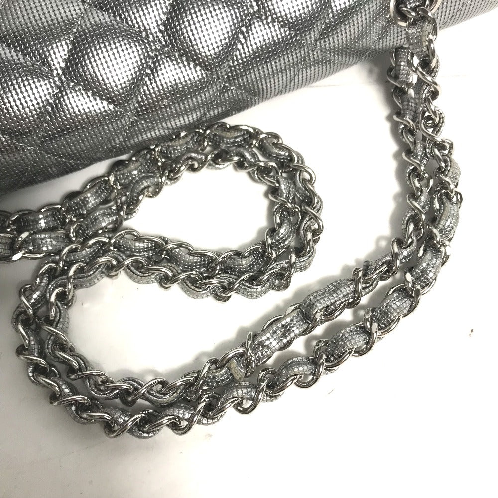 Silver chain necklace on a textured surface with a gray fabric background