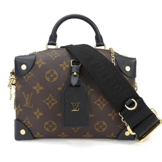 Designer handbag with monogram pattern and black strap on a white background