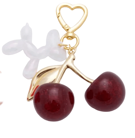 Gold balloon dog charm with red cherries on a white background