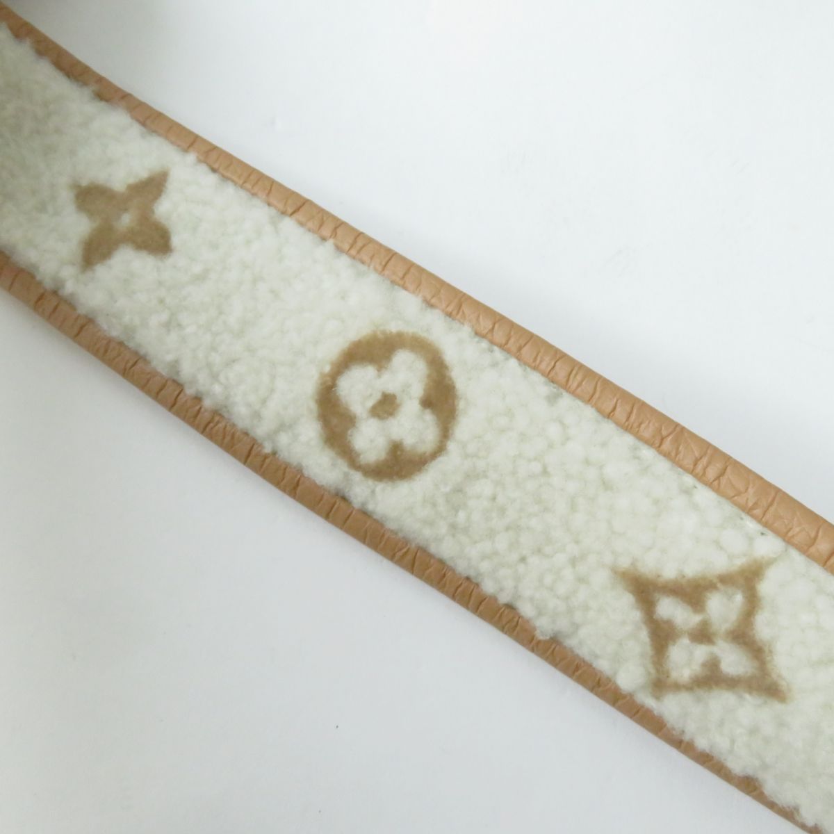 Close-up of a textured fabric strip with a pattern on a white background