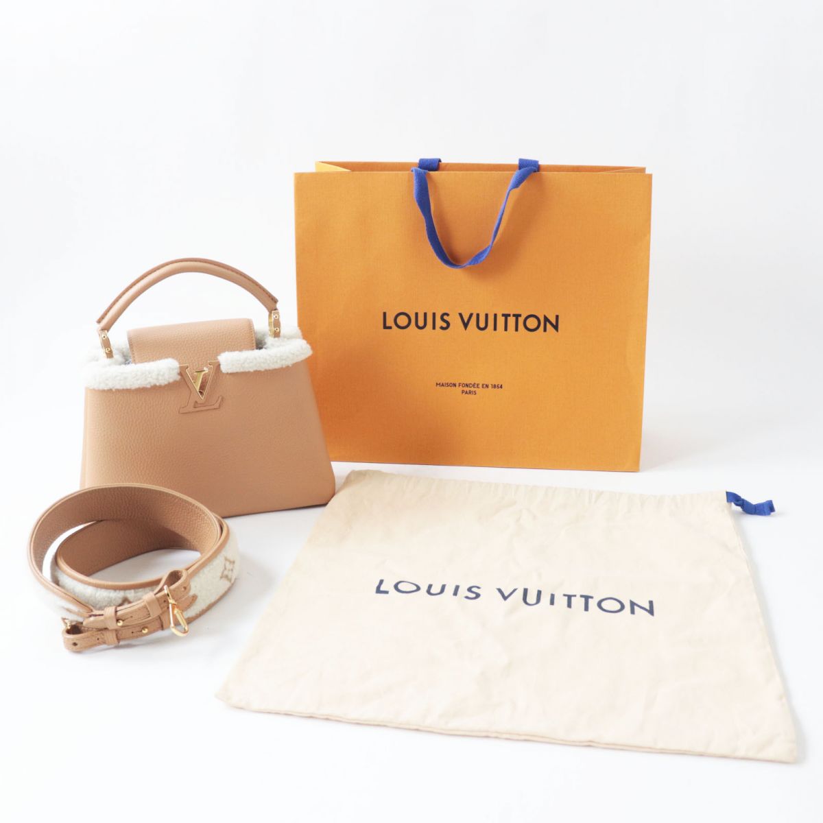Louis Vuitton handbag with matching pouch and belt on a white background