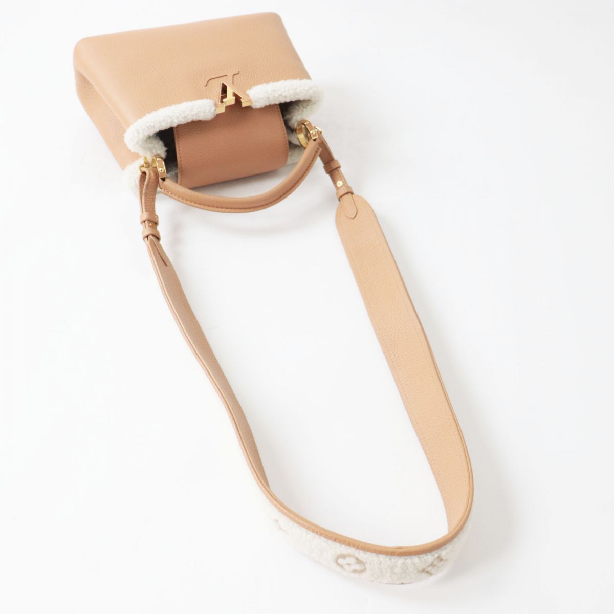 Beige handbag with shearling lining on a white background