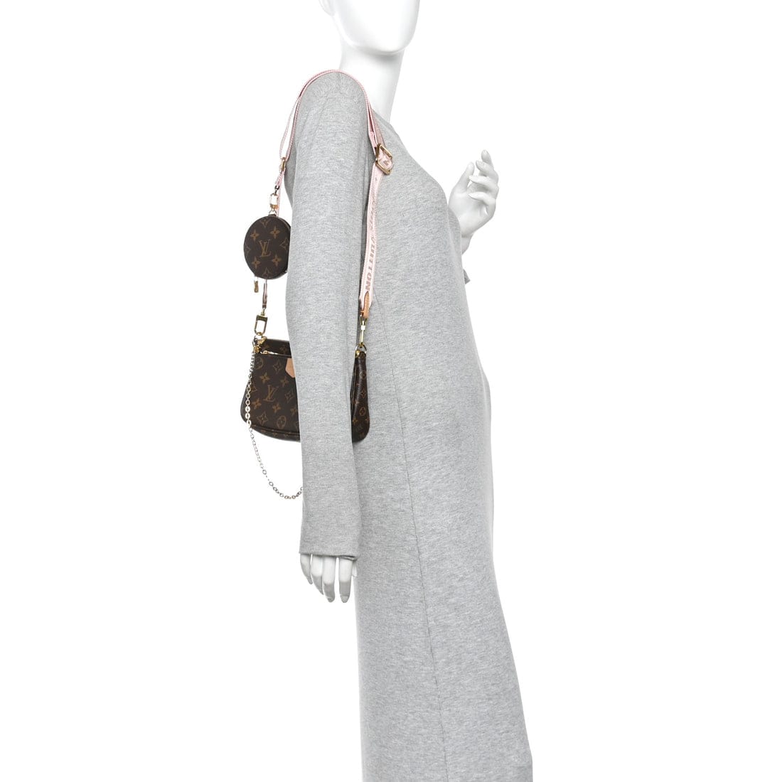 Mannequin wearing a gray scarf with a brown handbag on a white background