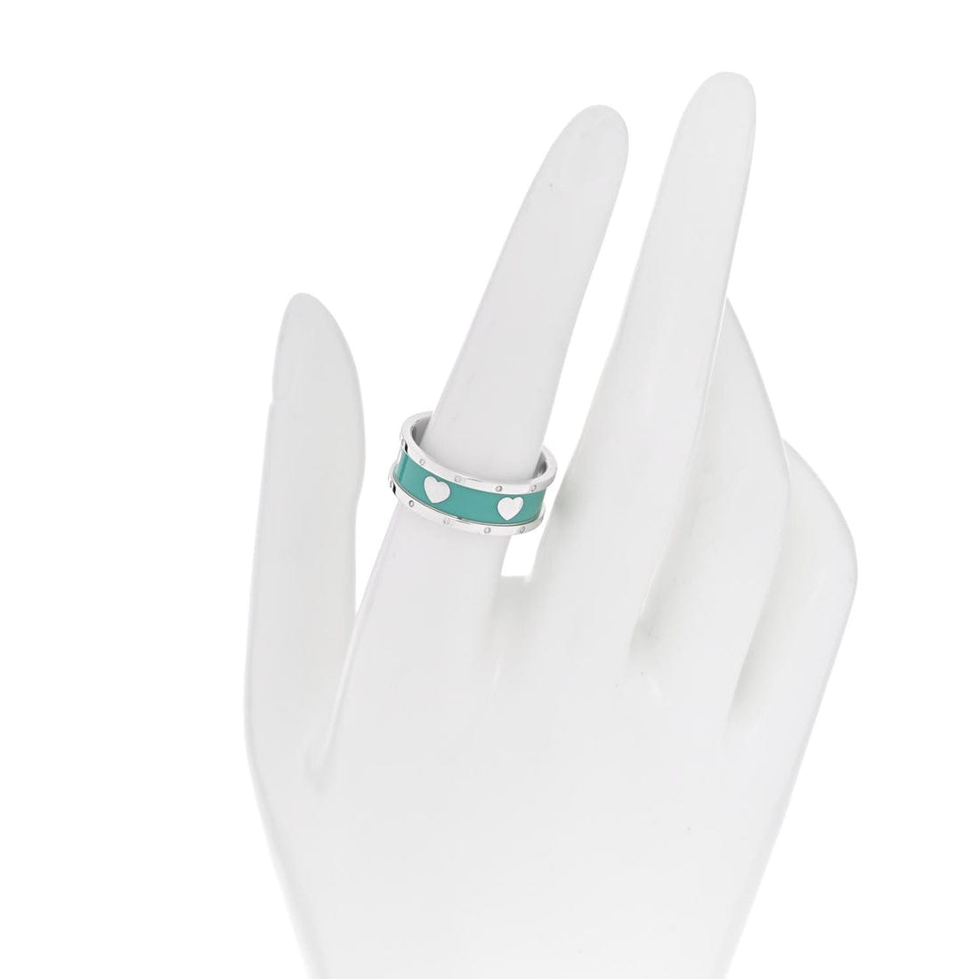 Turquoise ring with white polka dots on a white mannequin hand