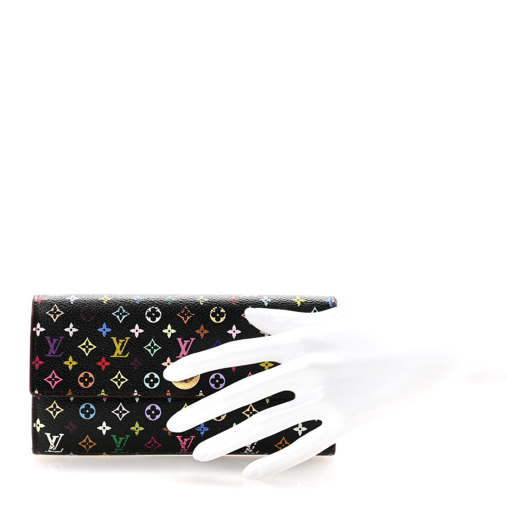 A Louis Vuitton monogram clutch bag in black coated canvas with multicolor monogram motifs, displayed on a white mannequin hand against a white background.