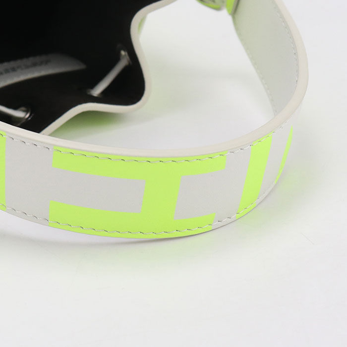 Close-up of a white belt with green accents on a light background