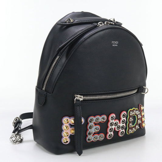 Black backpack with colorful 'FENDI' lettering and studs on a white background