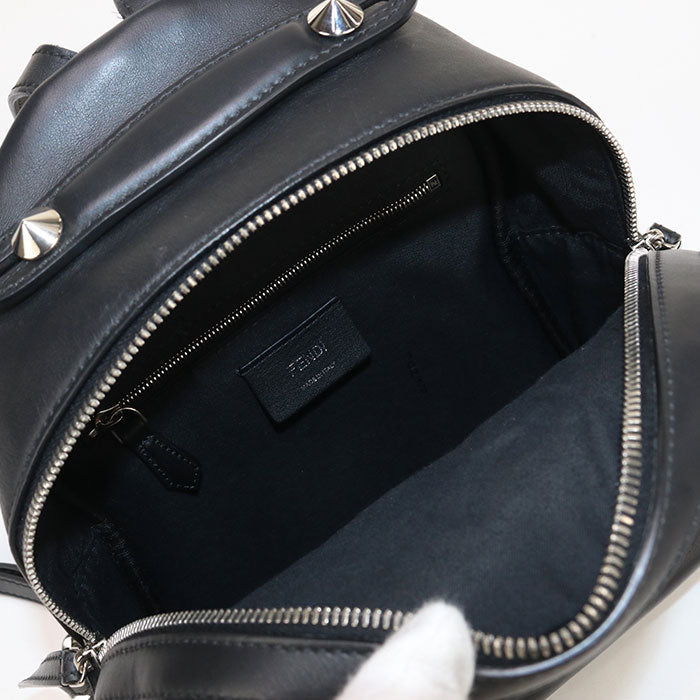 Black leather backpack with studded details and a visible brand label on a white background