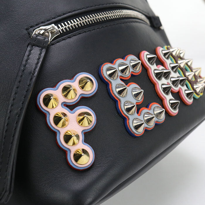 Black bag with colorful studded designs on a white background