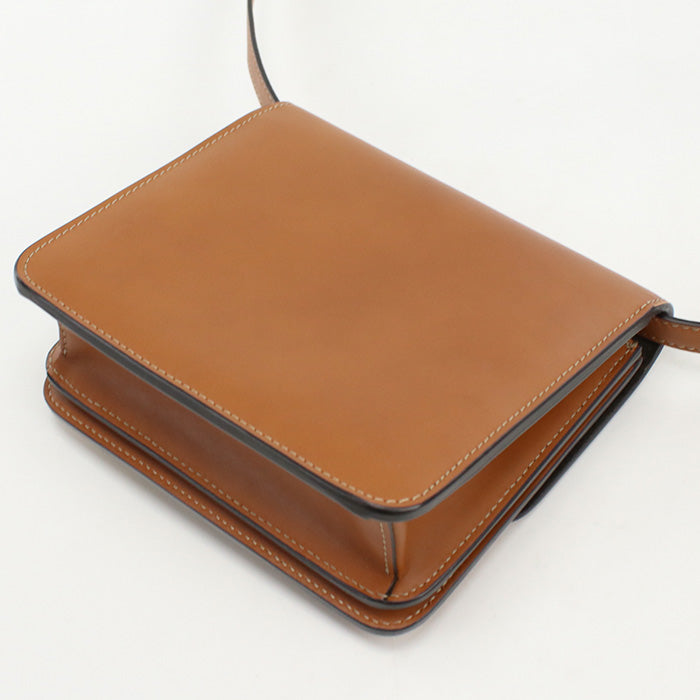 Brown leather handbag on a white background
