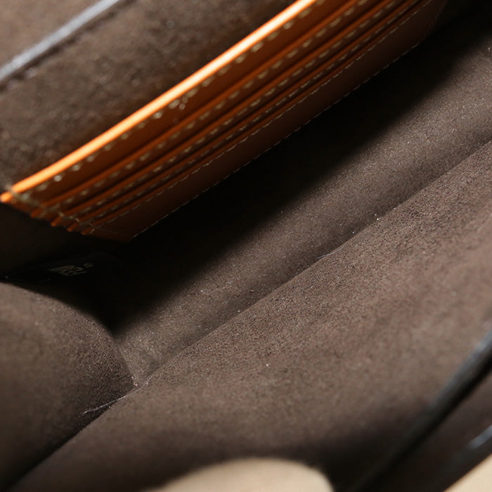 Close-up of a brown leather wallet with stitching detail