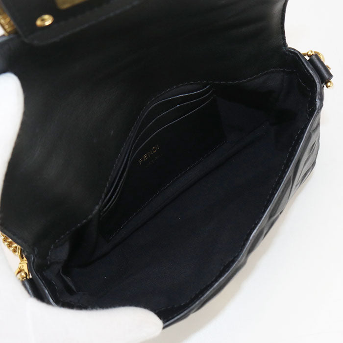 Black handbag with gold accents on a white background