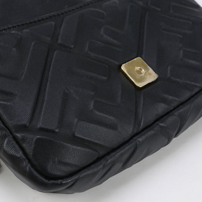 Black textured bag with a gold clasp on a white background
